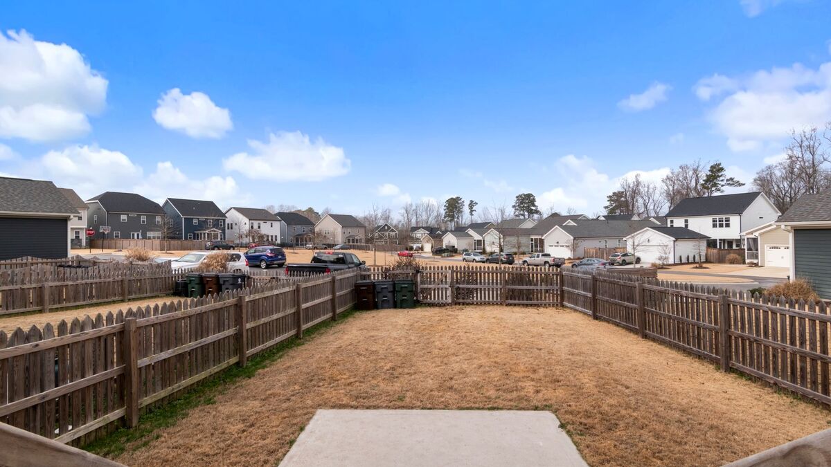 New wood privacy fences enclosing the backyards of a row of homes in a new subdivision